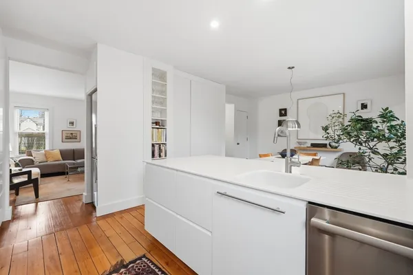 a kitchen with stainless steel appliances a stove a sink and a refrigerator