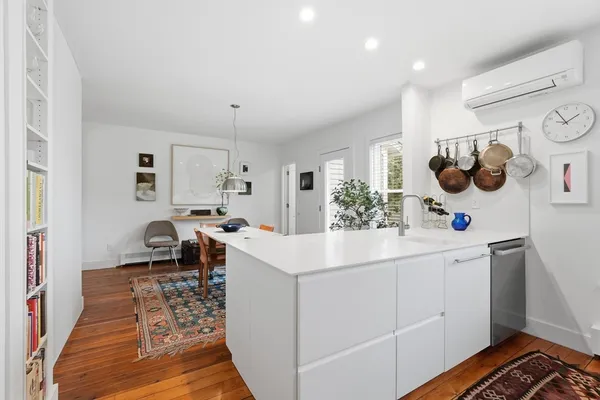 a kitchen with stainless steel appliances kitchen island granite countertop a sink a stove a table and chairs