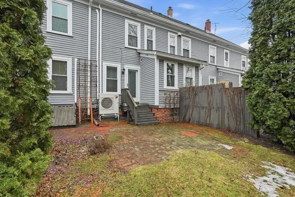 a blue umbrella sitting in front of a house
