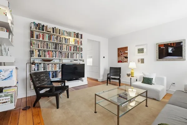 a bedroom with furniture and a rug