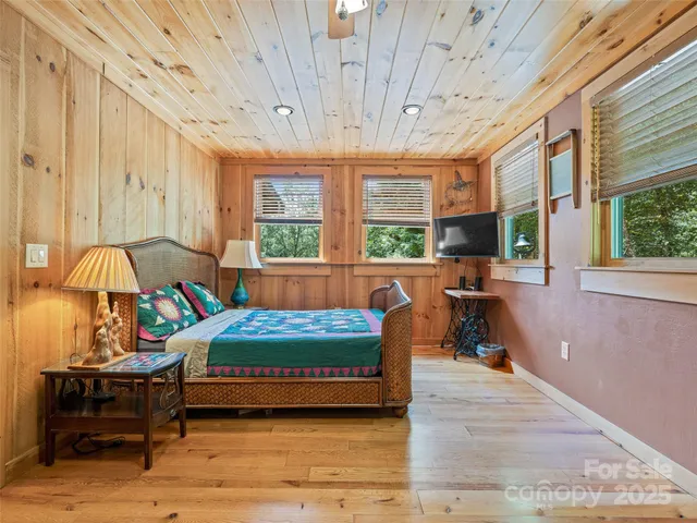 a bedroom with furniture and a large window