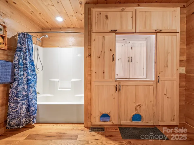 a bathroom with a toilet and a shower