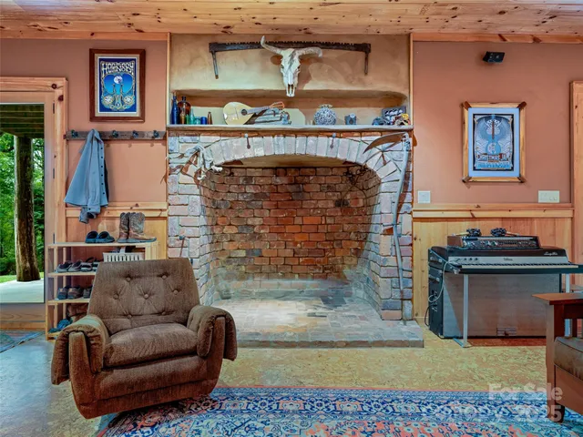 a bedroom with a bed and large windows