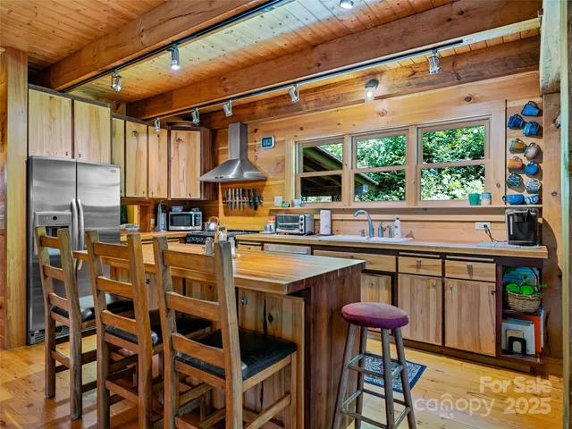 a open kitchen with stainless steel appliances granite countertop a stove and a refrigerator