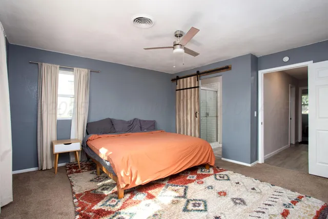 a bedroom with a bed and a window