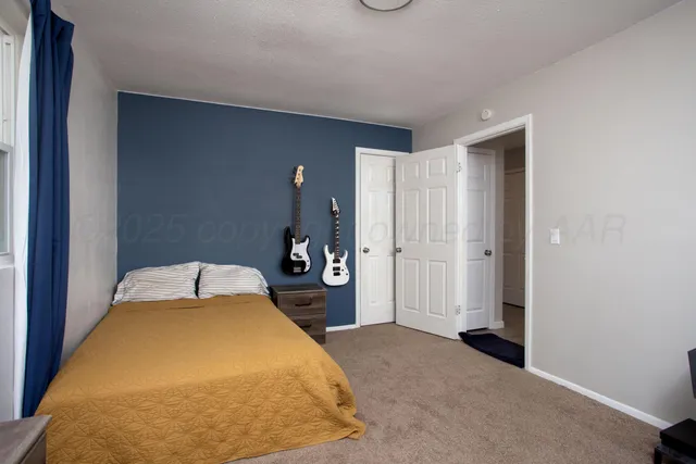 a bedroom with a bed and a closet