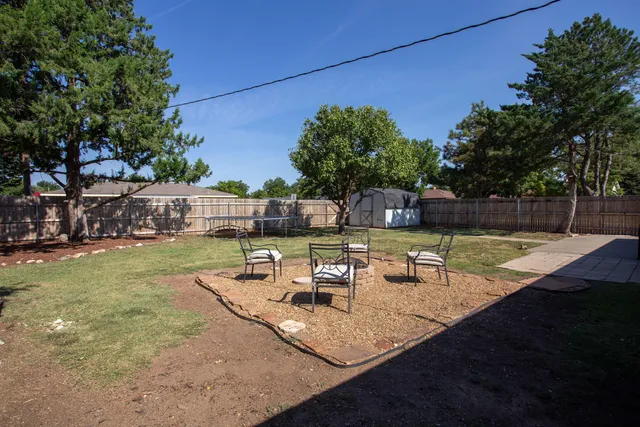 a view of a backyard with sitting area