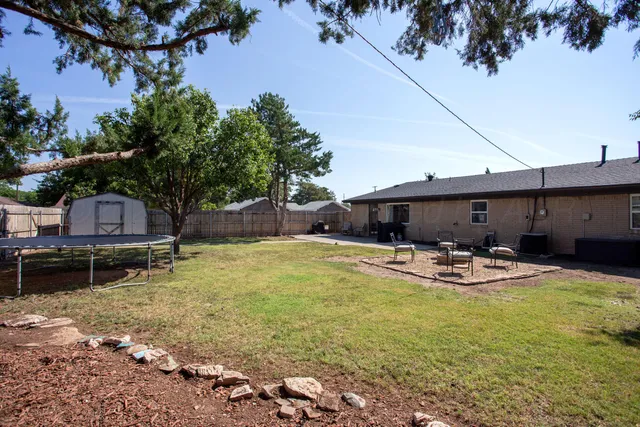 a view of a swimming pool with chair and tables