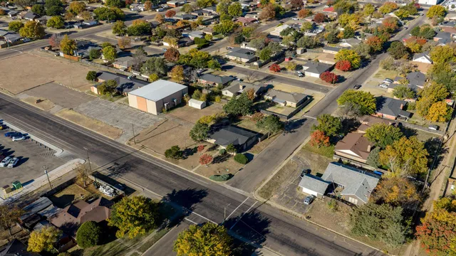 an aerial view of multiple houses with yard