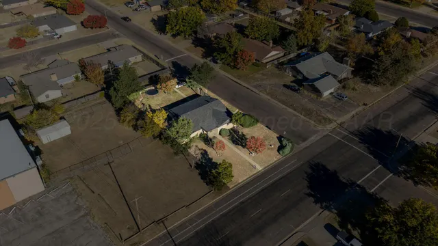an aerial view of a house with a yard