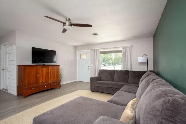 a living room with furniture and a flat screen tv