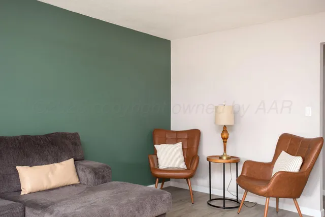 a living room with furniture and a chair