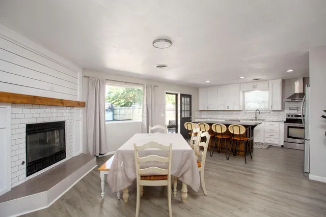 a view of a a dining room with furniture window and wooden floor