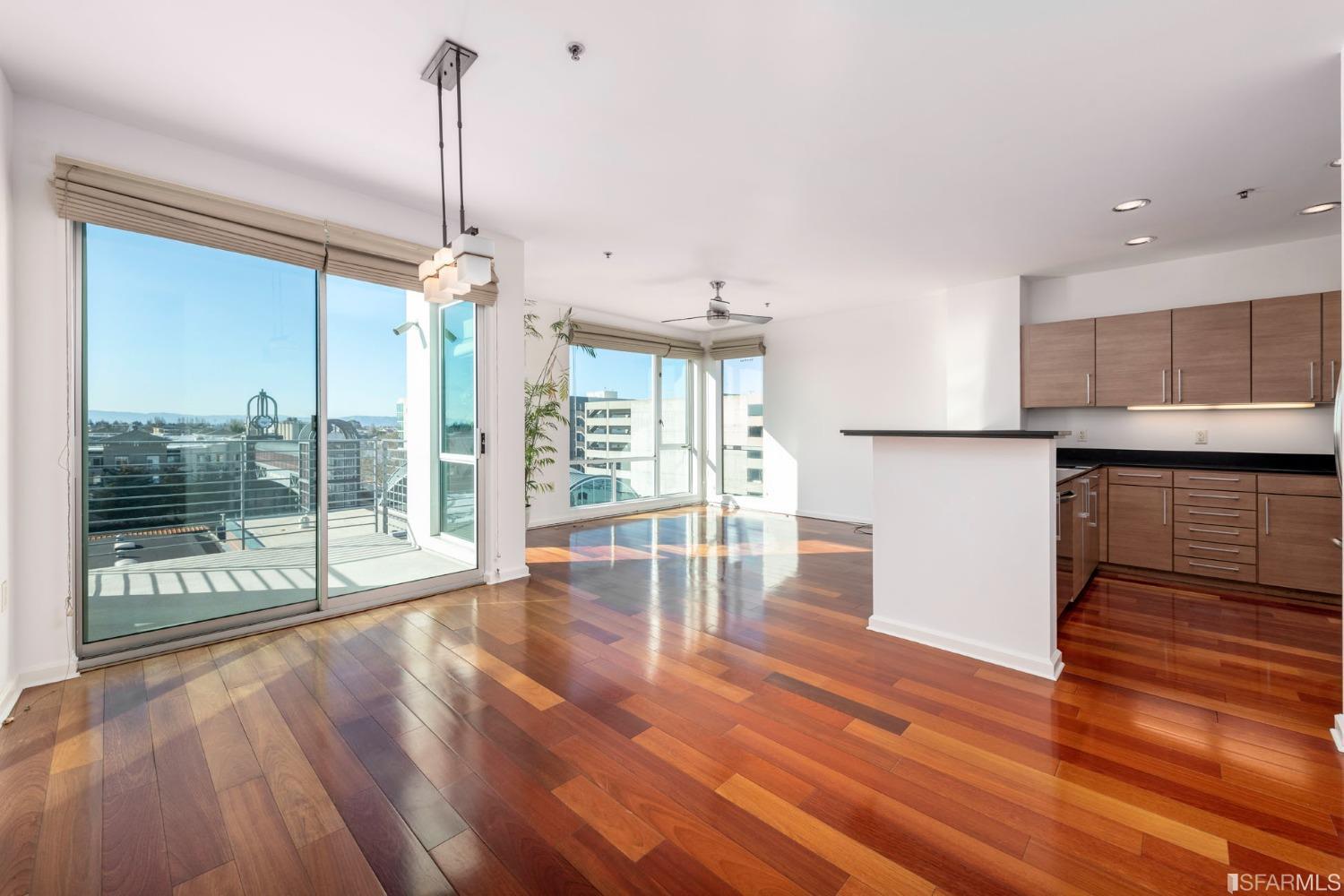 200 2nd Street, Unit 514 Oakland, CA 94607 - Photo 13 of 26 a open kitchen with granite countertop a stove and a wooden floor