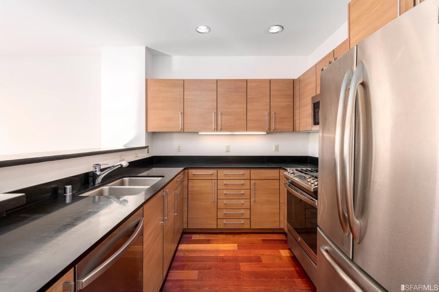 200 2nd Street, Unit 514 Oakland, CA 94607 - Photo 16 of 26 a kitchen with stainless steel appliances granite countertop a refrigerator and a sink