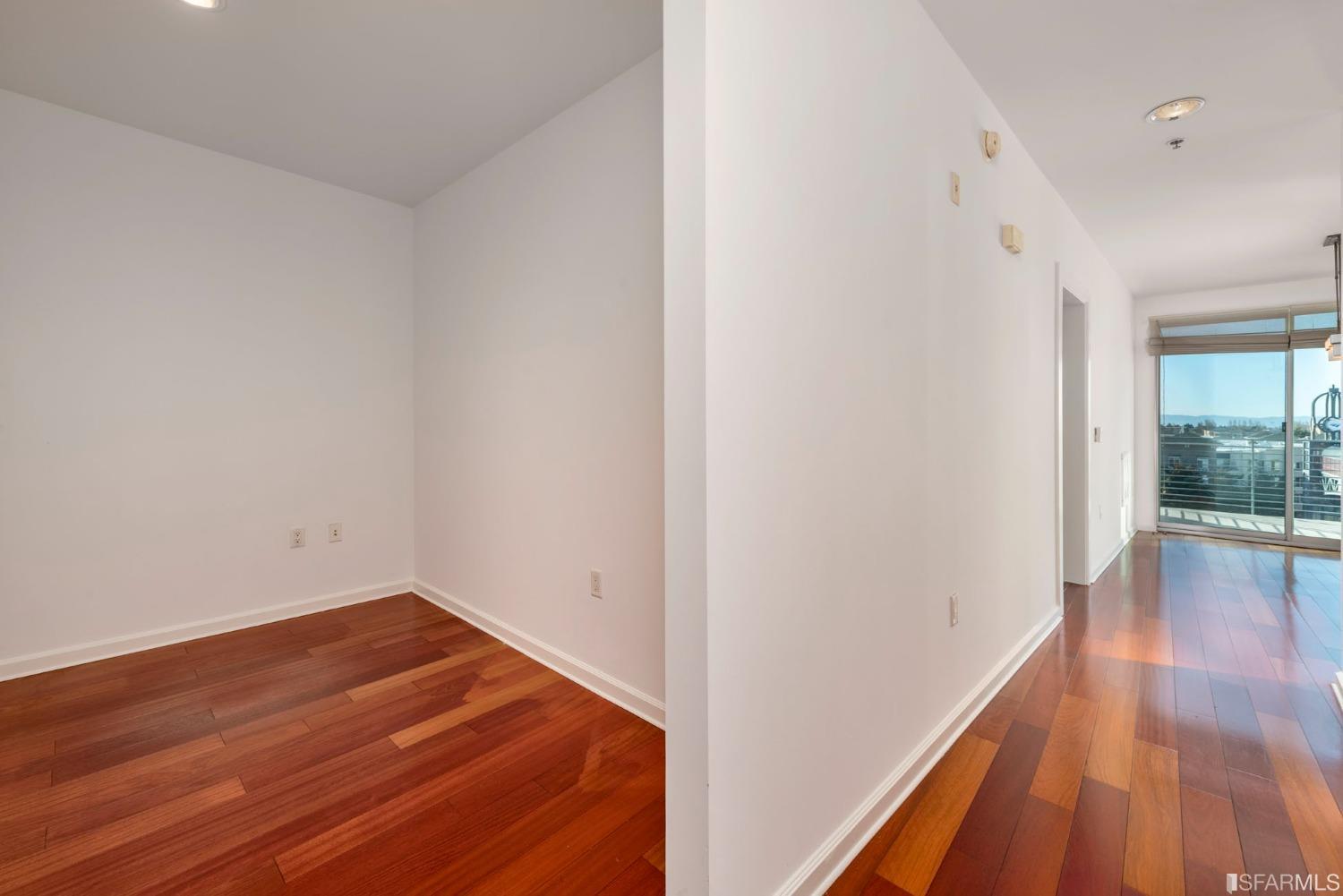 200 2nd Street, Unit 514 Oakland, CA 94607 - Photo 23 of 26 a view of a room with wooden floor and iron gate