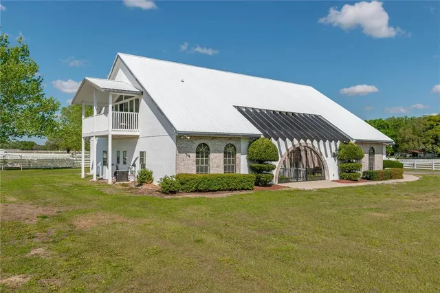 a view of a house with backyard and sitting area