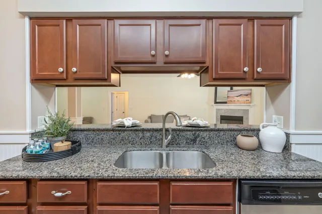 a kitchen with granite countertop stainless steel appliances sink microwave and cabinets