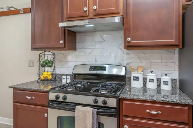 a stove top oven sitting inside of a kitchen