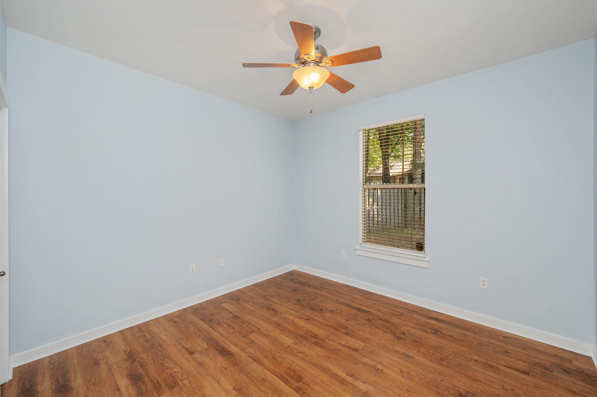 318 Key Lime Place Crestview, FL 32536 - Photo 20 of 30 an empty room with wooden floor and windows
