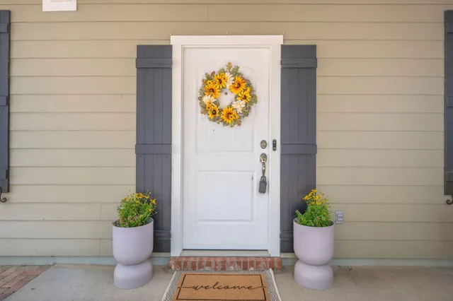 a white vase with flowers