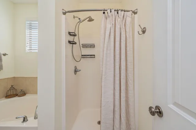 a bathroom with a shower and a sink