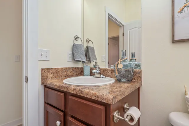 a bathroom with a granite countertop sink and a mirror