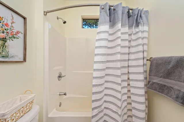 a bathroom with a bathtub and shower