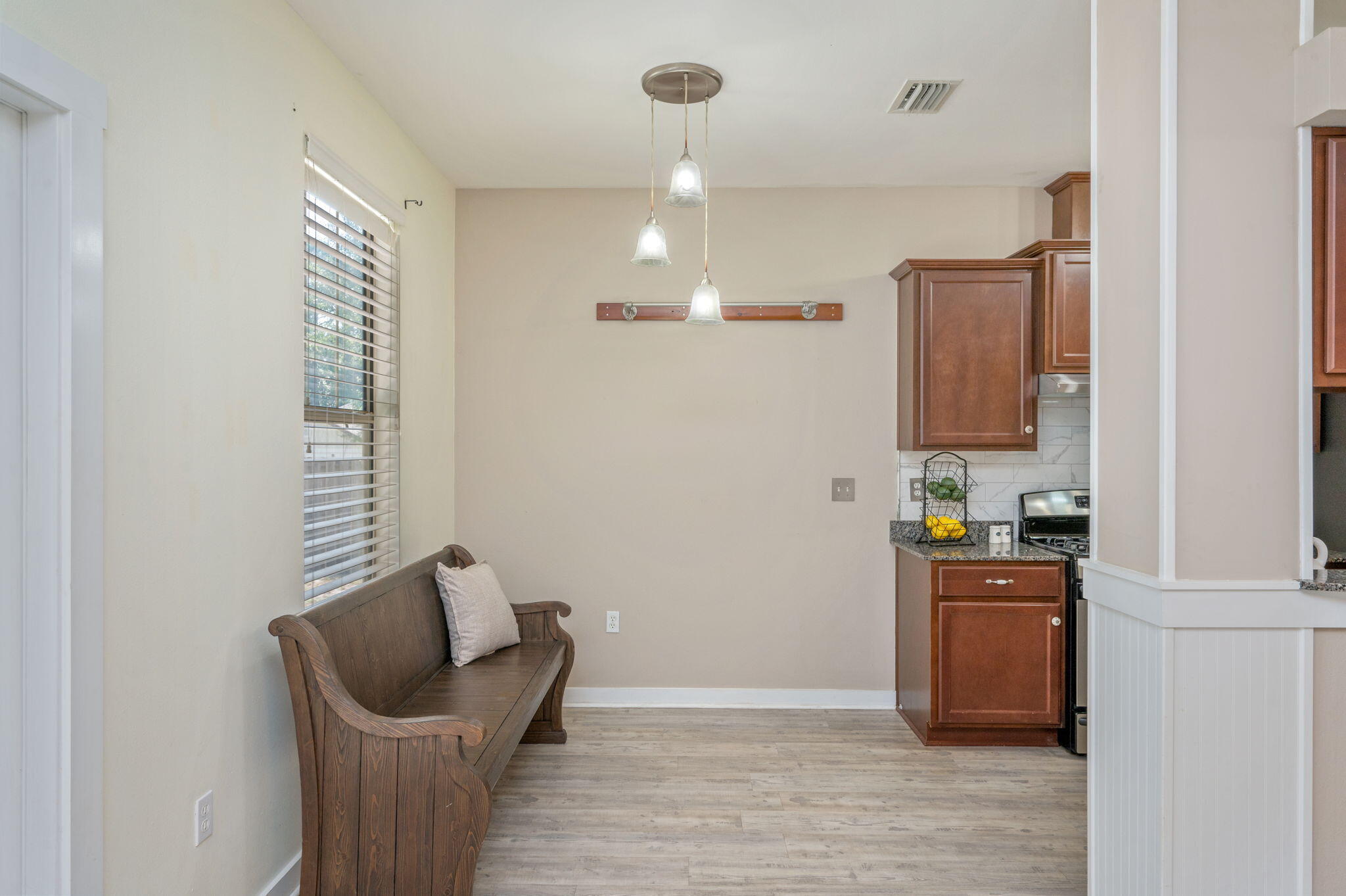 318 Key Lime Place Crestview, FL 32536 - Photo 8 of 30 a kitchen with granite countertop a sink and a wooden floor