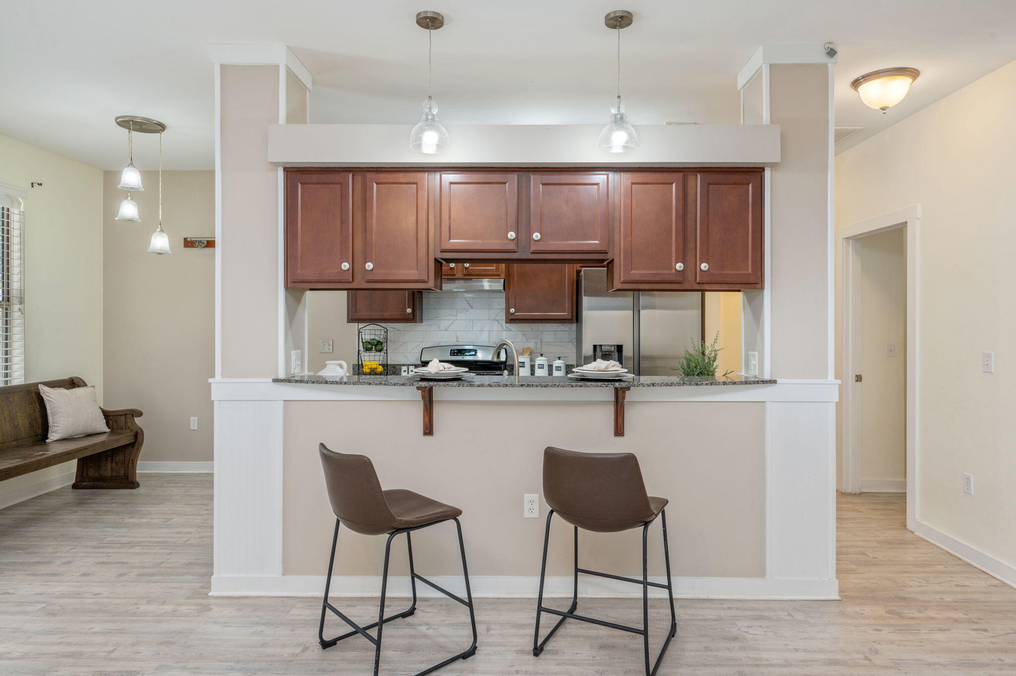 318 Key Lime Place Crestview, FL 32536 - Photo 9 of 30 a kitchen with a refrigerator a stove a sink and a dining table with wooden floor