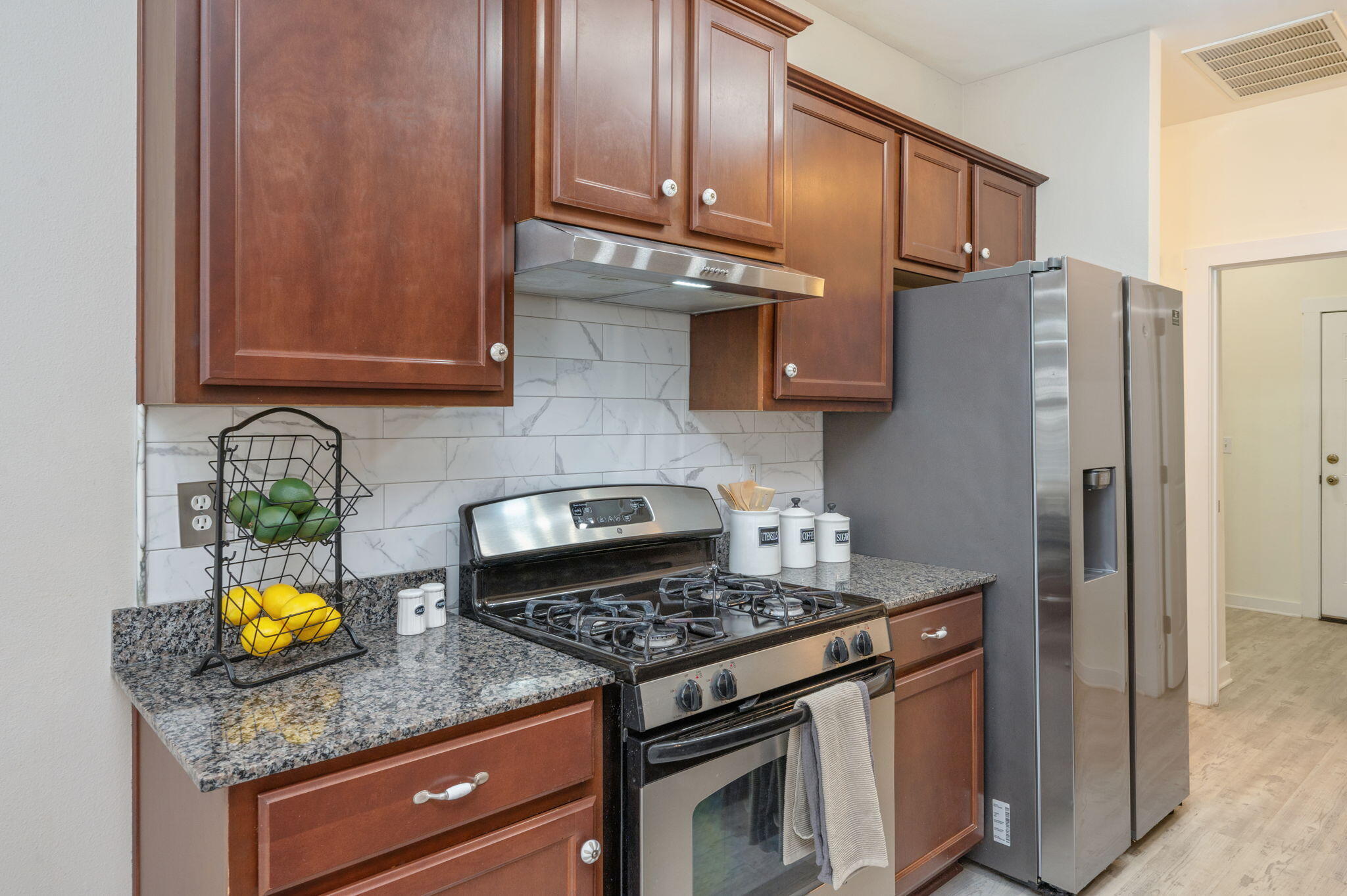 318 Key Lime Place Crestview, FL 32536 - Photo 10 of 30 a kitchen with stainless steel appliances granite countertop a stove a refrigerator and a sink