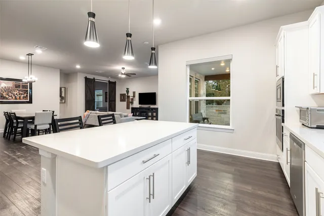 a living room with furniture and kitchen view