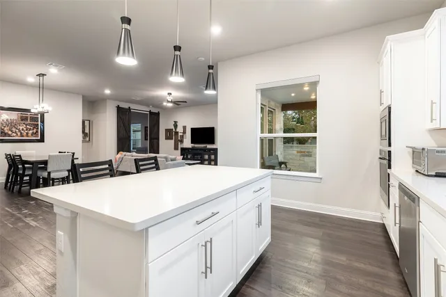 a living room with furniture and kitchen view