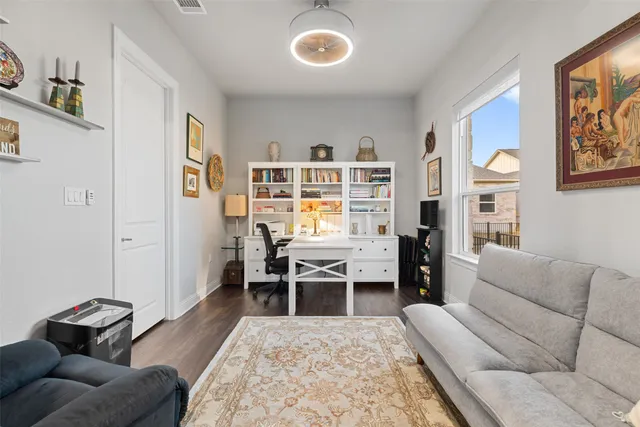 a view of a a dining room with furniture window and wooden floor