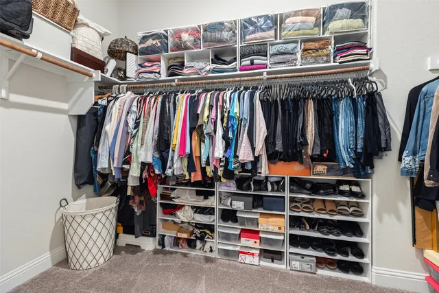 a kitchen with a sink white cabinets and refrigerator