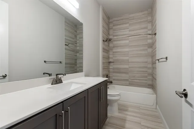 a spacious bedroom with a bed and a large window