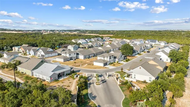 an aerial view of residential building with outdoor space and ocean view