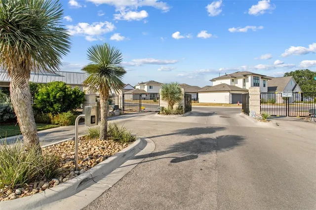 a front view of a house with palm trees