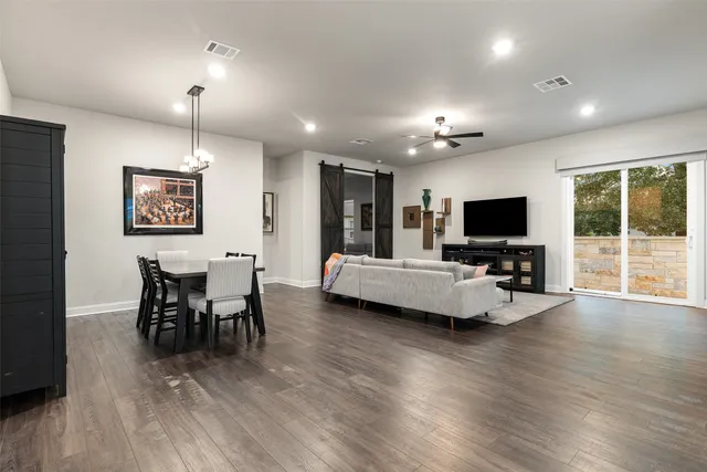 a front view of a house with a yard and trees