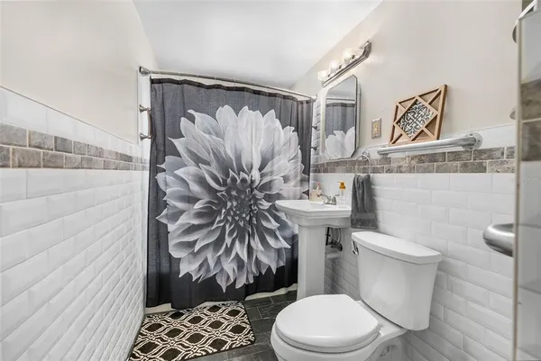 a white toilet sitting next to a bathroom sink