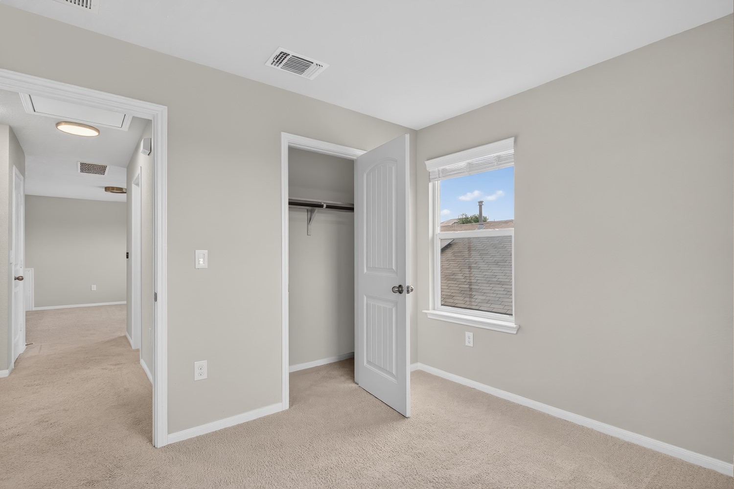 2006 Grow Lane Austin, TX 78754 - Photo 23 of 40 A well-lit bedroom features plush carpet and an ample closet, providing a comfortable personal retreat.