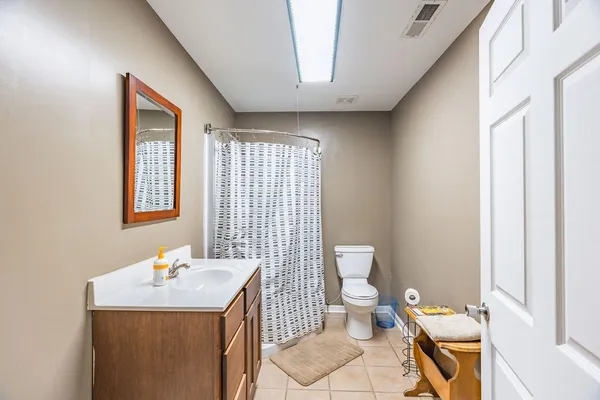 a bed room with a bed and a chair