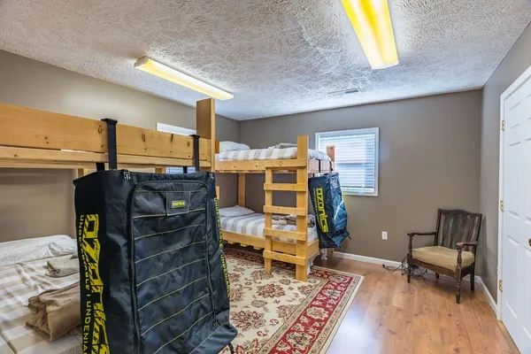 a bedroom with a bed and wooden floor