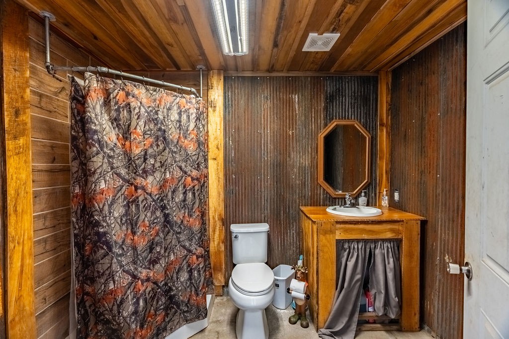 8496 South Madisonville Road Crofton, KY 42217 - Photo 18 of 22 a bathroom with a toilet sink and mirror