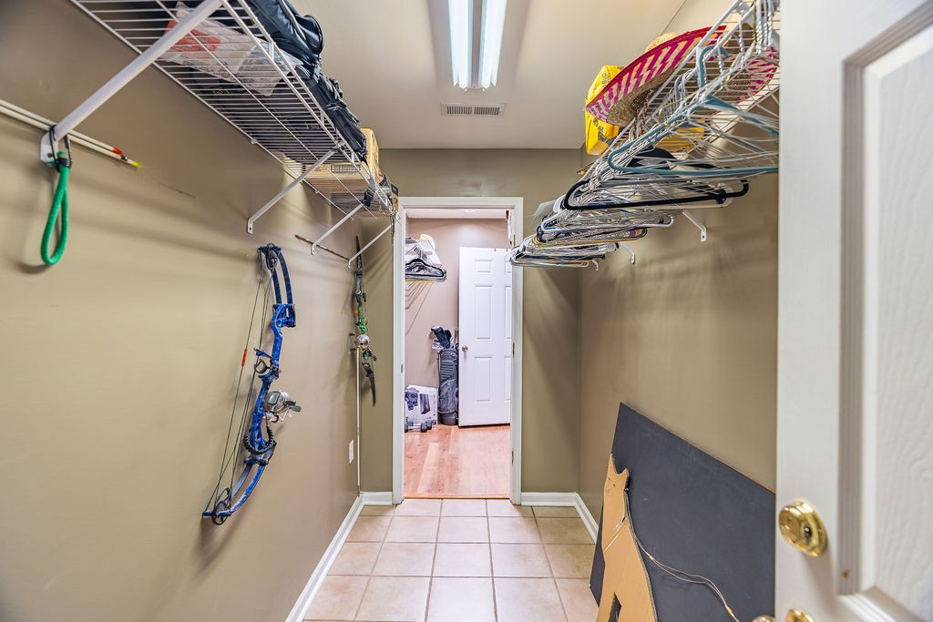 8496 South Madisonville Road Crofton, KY 42217 - Photo 21 of 22 a view of walk in closet with clothes and shoes