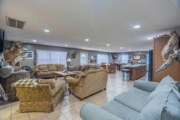 a dining hall with stainless steel appliances a dining table and chairs