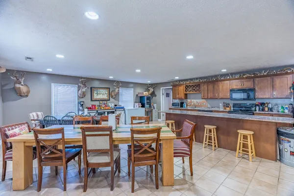 a kitchen with a table and chairs in it