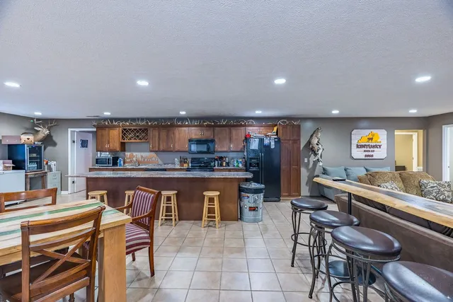a large kitchen with stainless steel appliances granite countertop a large counter top and a stove