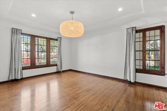 a kitchen with stainless steel appliances white cabinets and a refrigerator