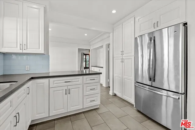 a view of empty room with wooden floor and cabinet
